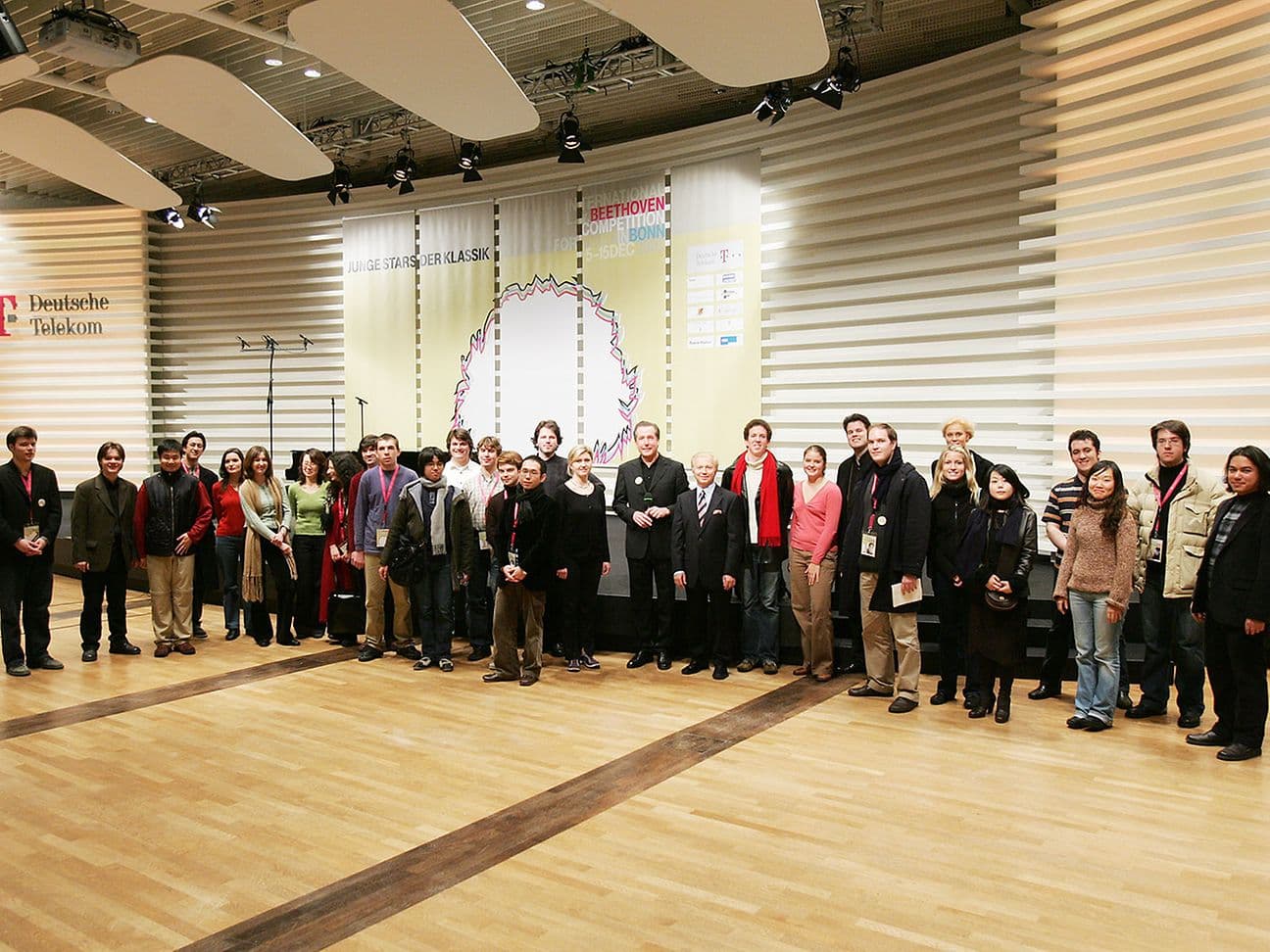 Group of people posing on a stage at an event by Deutsche Telekom