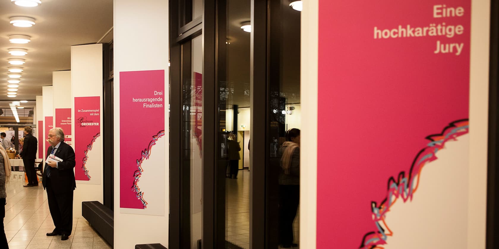 Posters in a corridor with the inscriptions 'Three outstanding finalists' and 'A distinguished jury'.