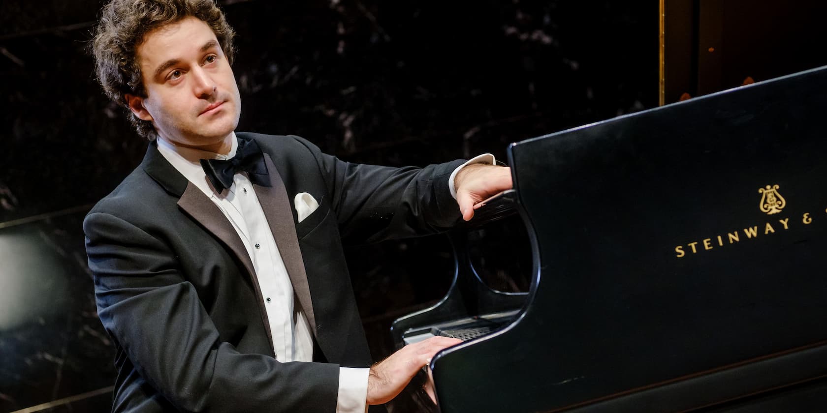 Man in a tuxedo playing piano