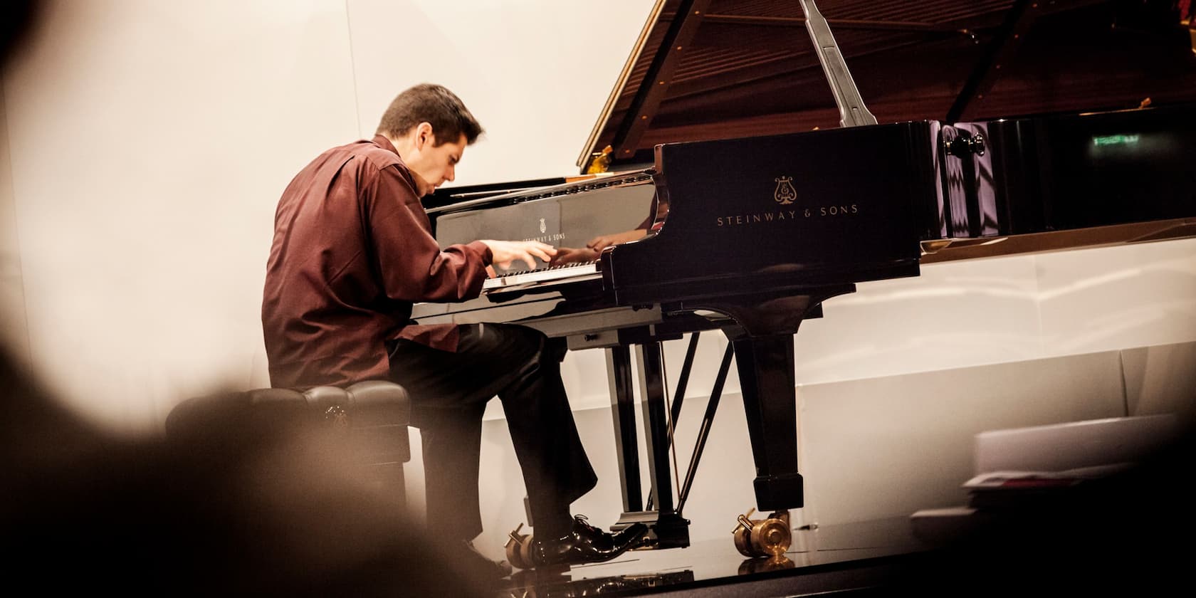 A man playing the piano on a stage.