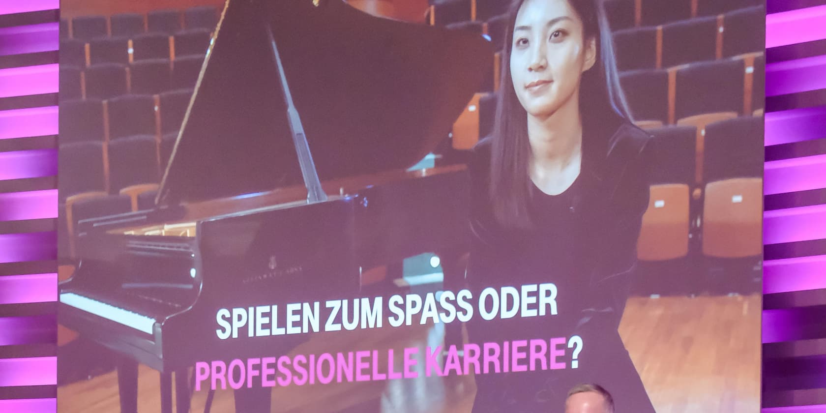 A woman sits next to a grand piano. Text: Playing for fun or professional career?