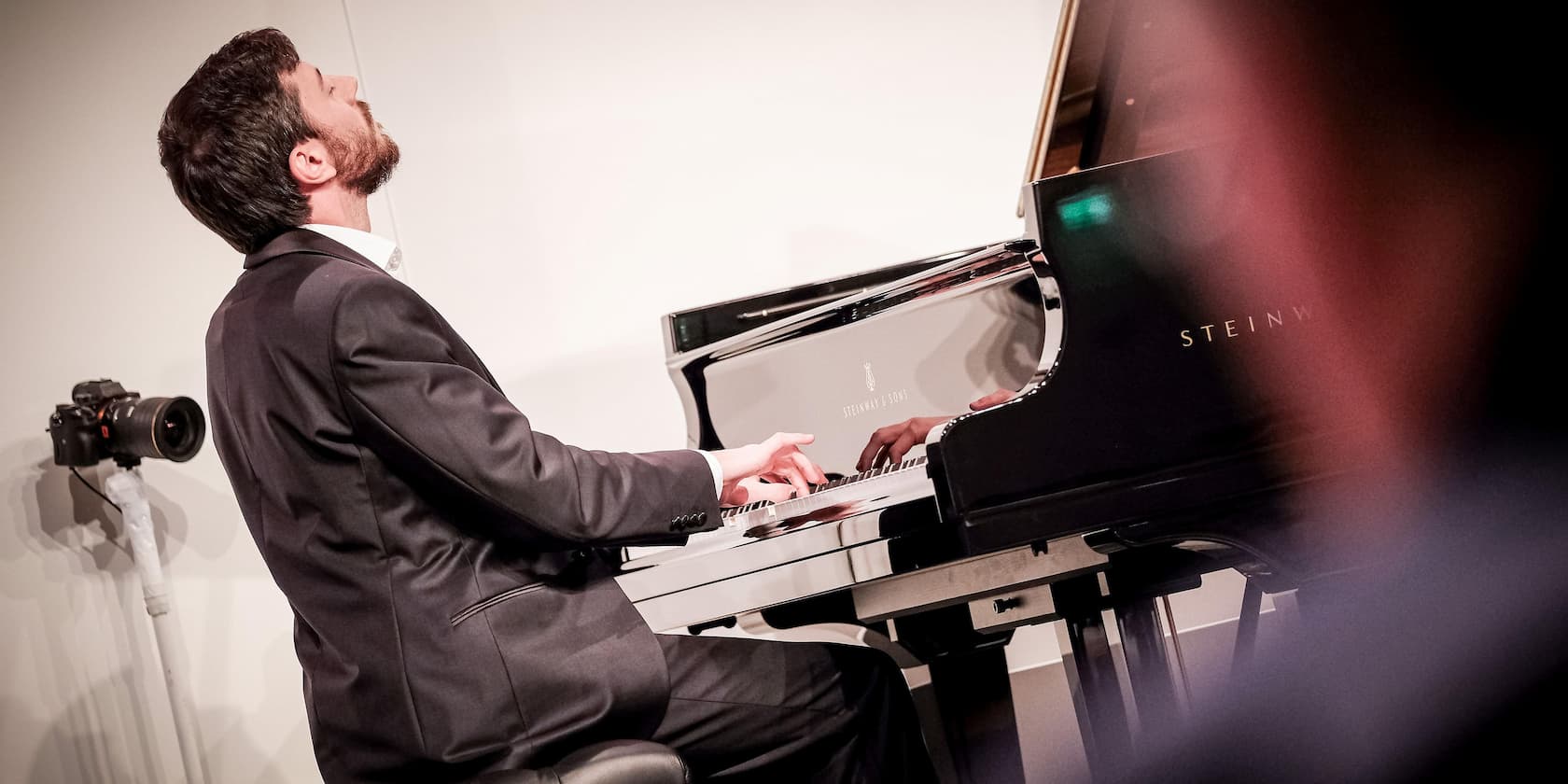 Man playing a Steinway & Sons grand piano.