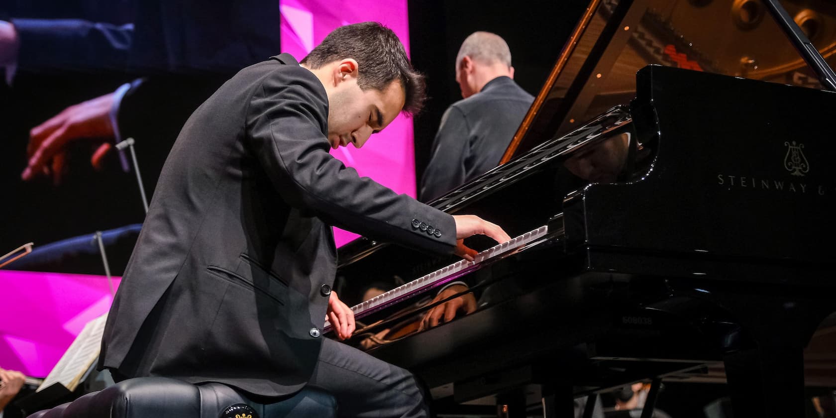 Man playing piano with concentration during a concert.