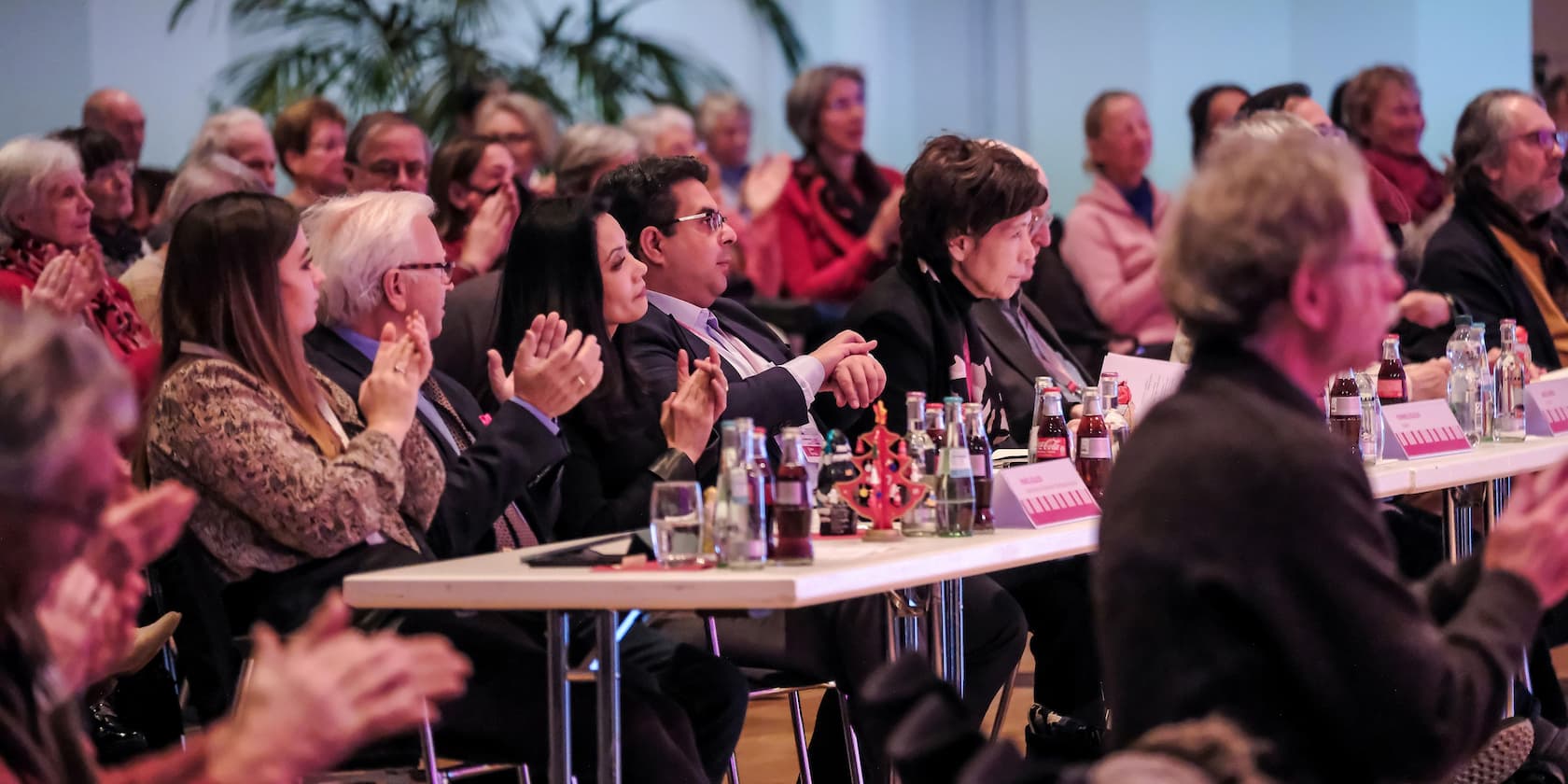 People clapping during an event.