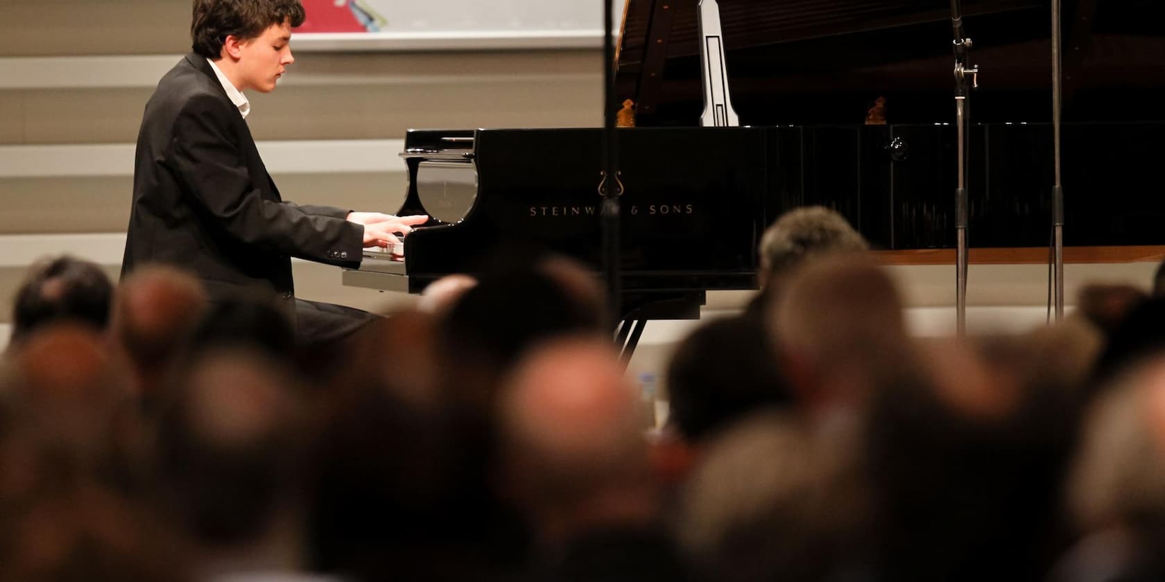 Pianist playing the piano in front of an audience