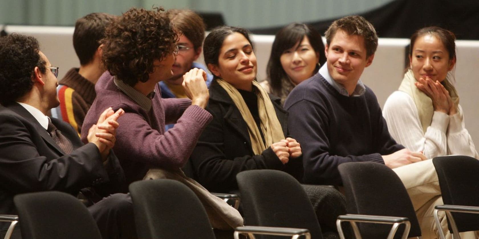 Group of people sitting at an event, engaged in conversation.