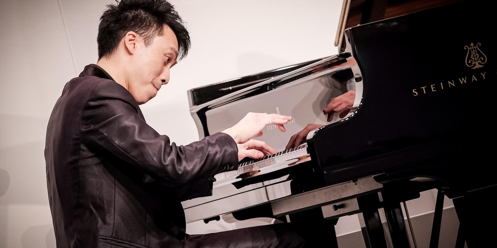 Man playing a Steinway & Sons piano