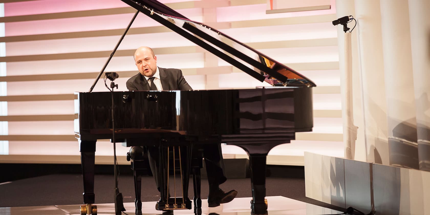 A man playing piano on a stage.