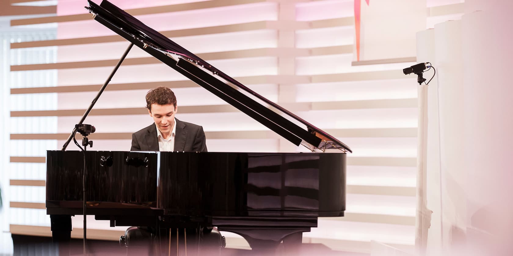 A man playing the piano on a stage.