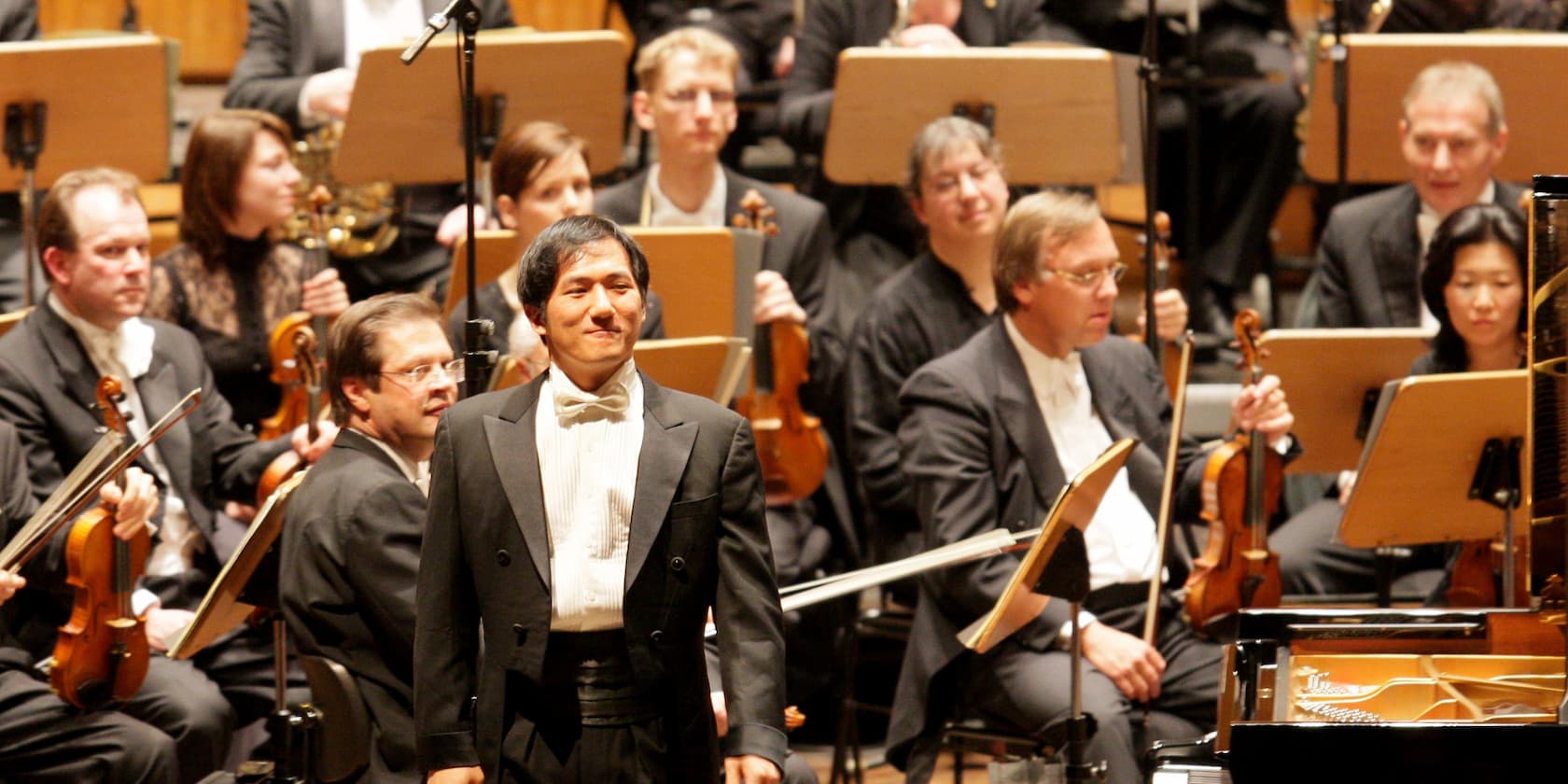 Conductor and orchestra on a stage just before the start of a concert