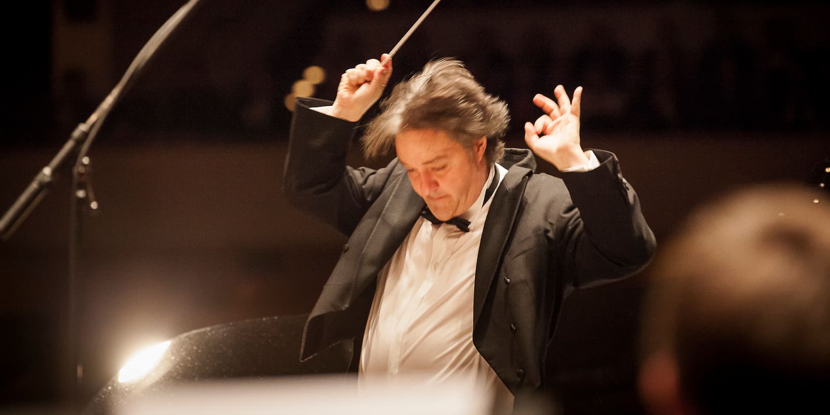 Conductor leading an orchestra