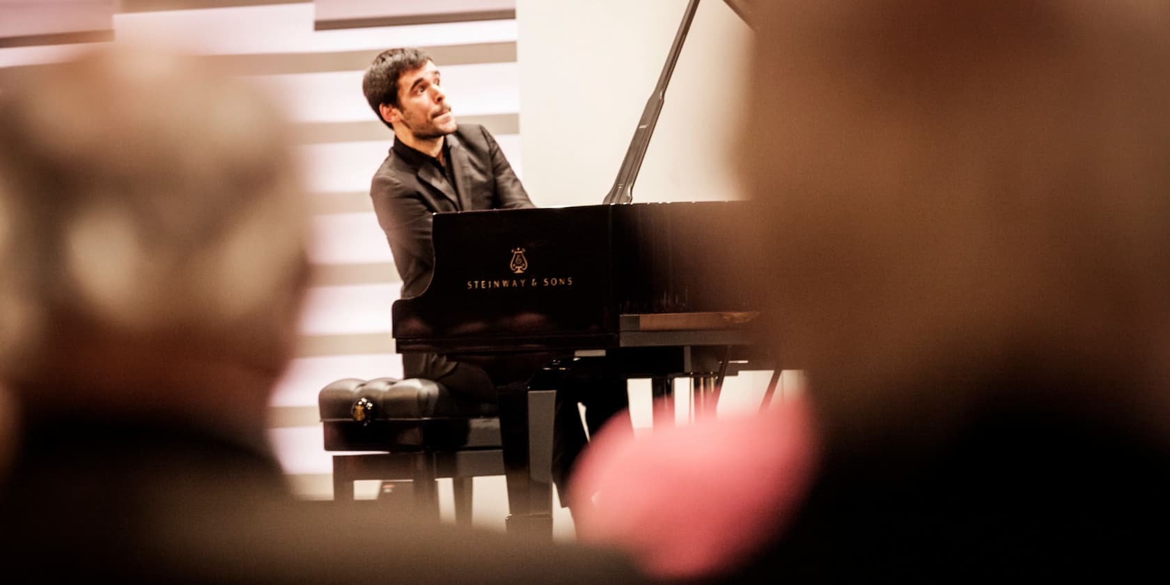 A pianist playing a Steinway & Sons piano during a concert.