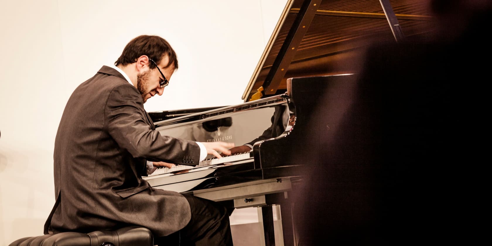 A man in a suit playing the piano