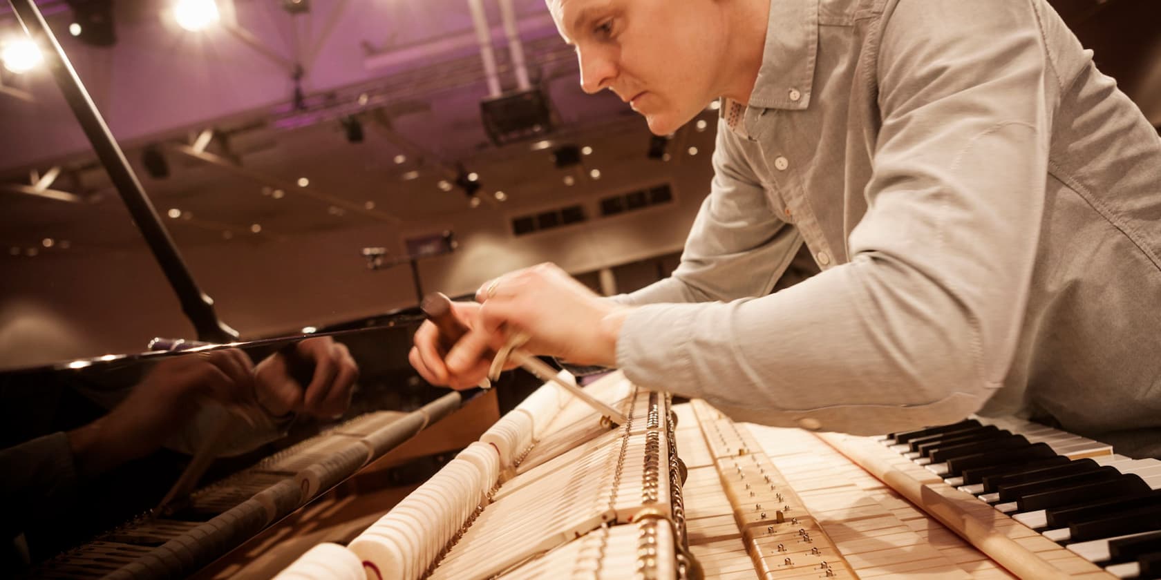 A person tuning a piano.