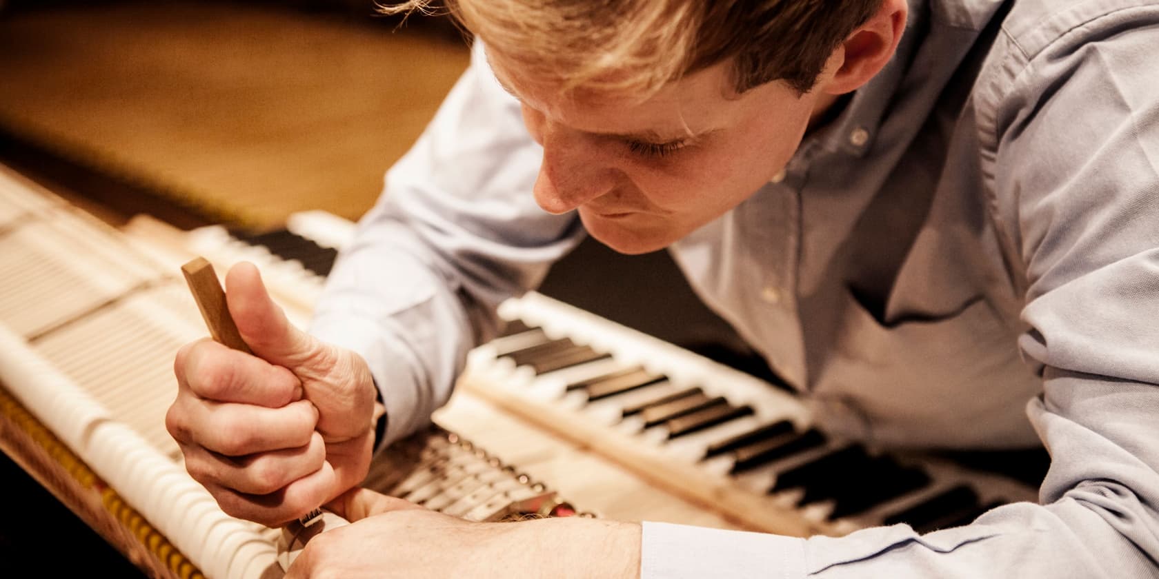 Man repairing a piano