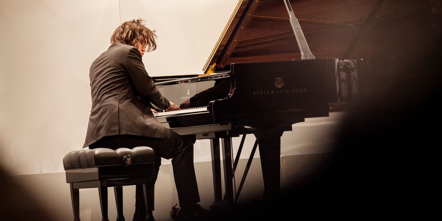 A person playing on a Steinway & Sons grand piano.