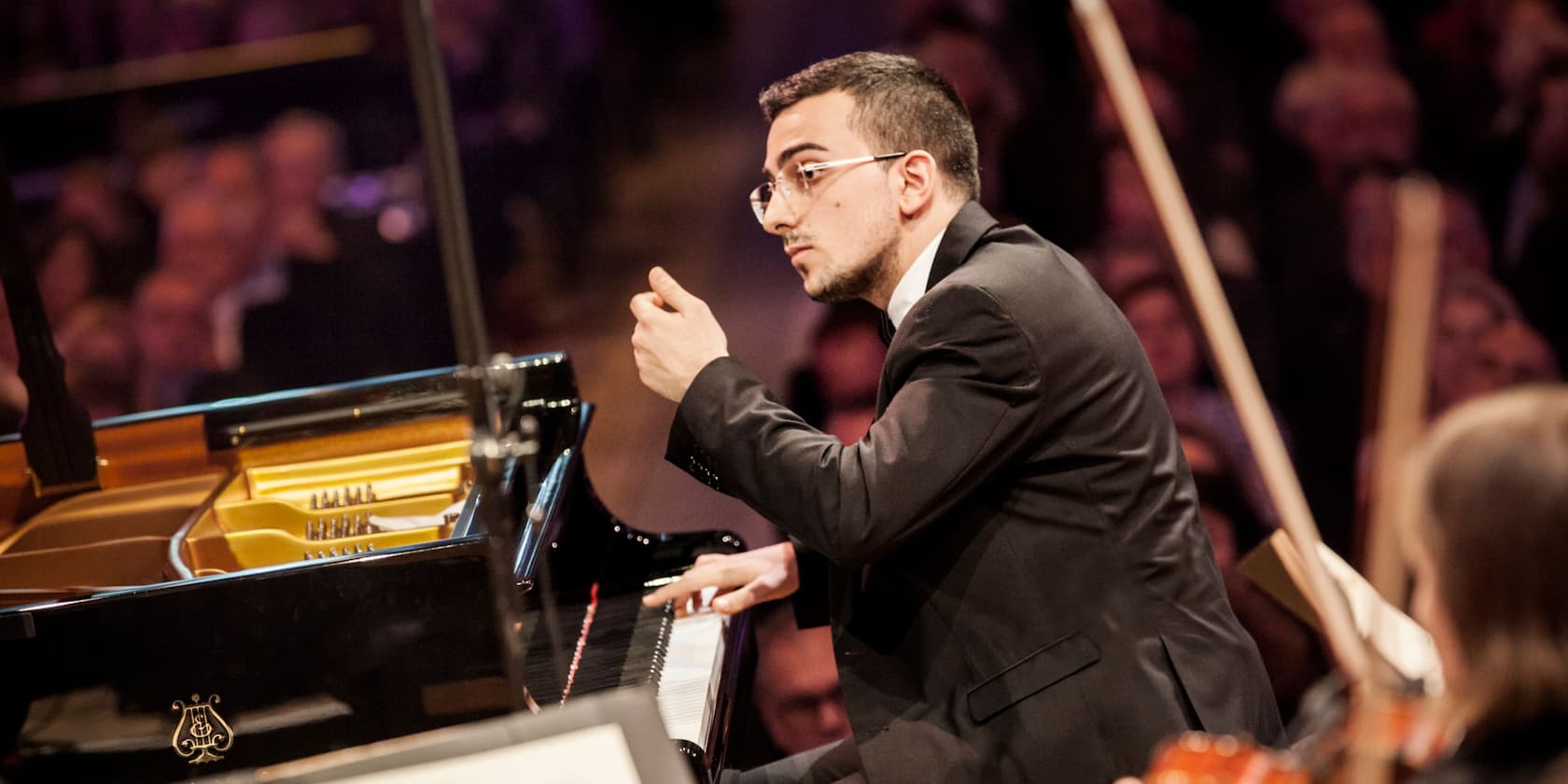 A pianist playing piano at a concert.