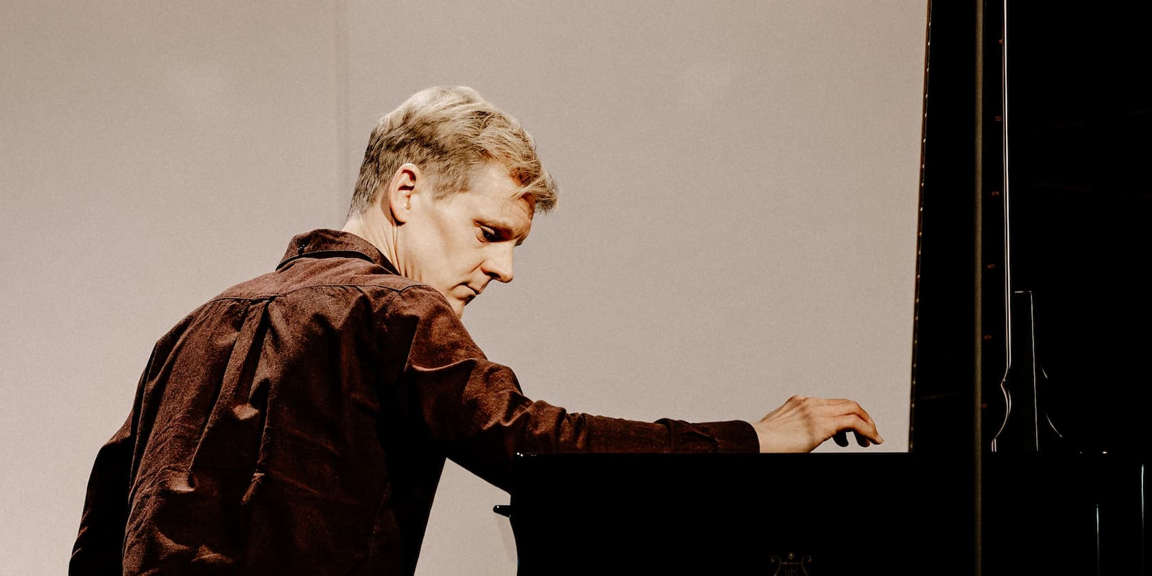 A man playing piano with concentration.