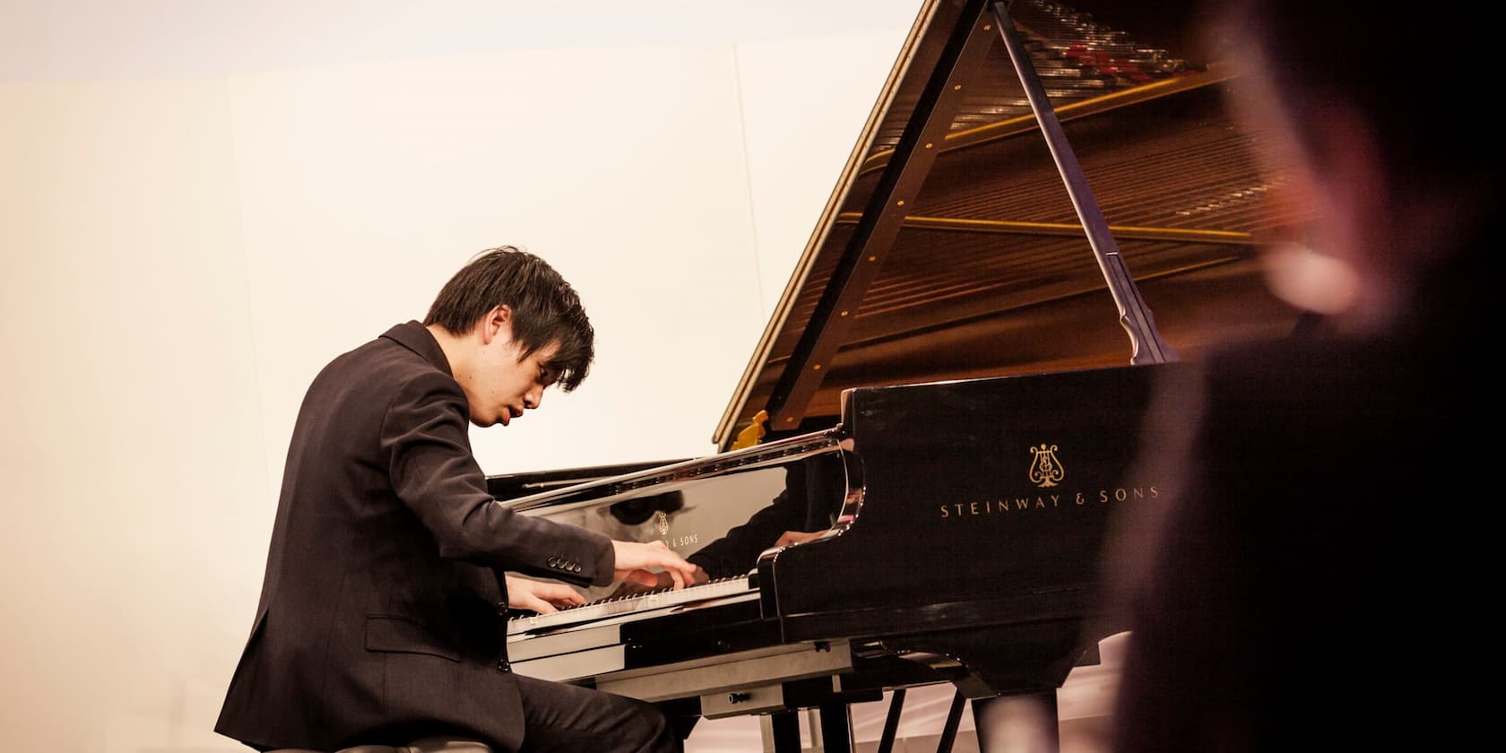 Man playing a Steinway & Sons grand piano