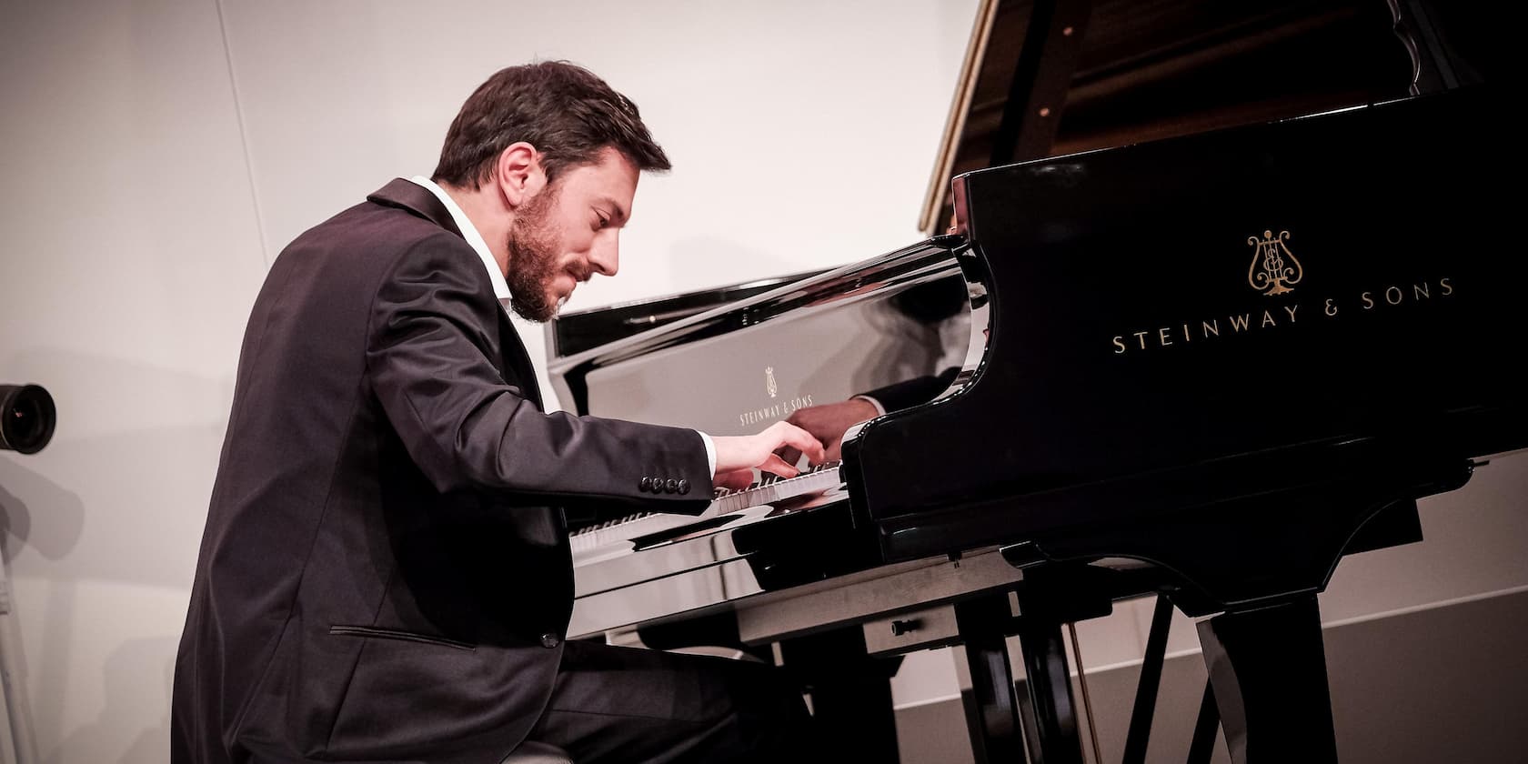 Man in a suit playing piano