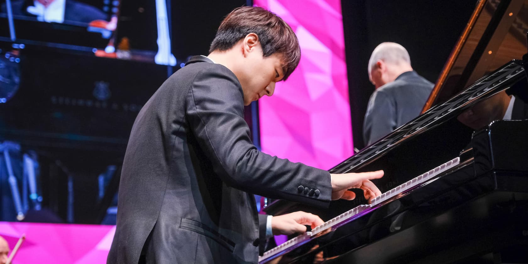 A man playing piano on stage.