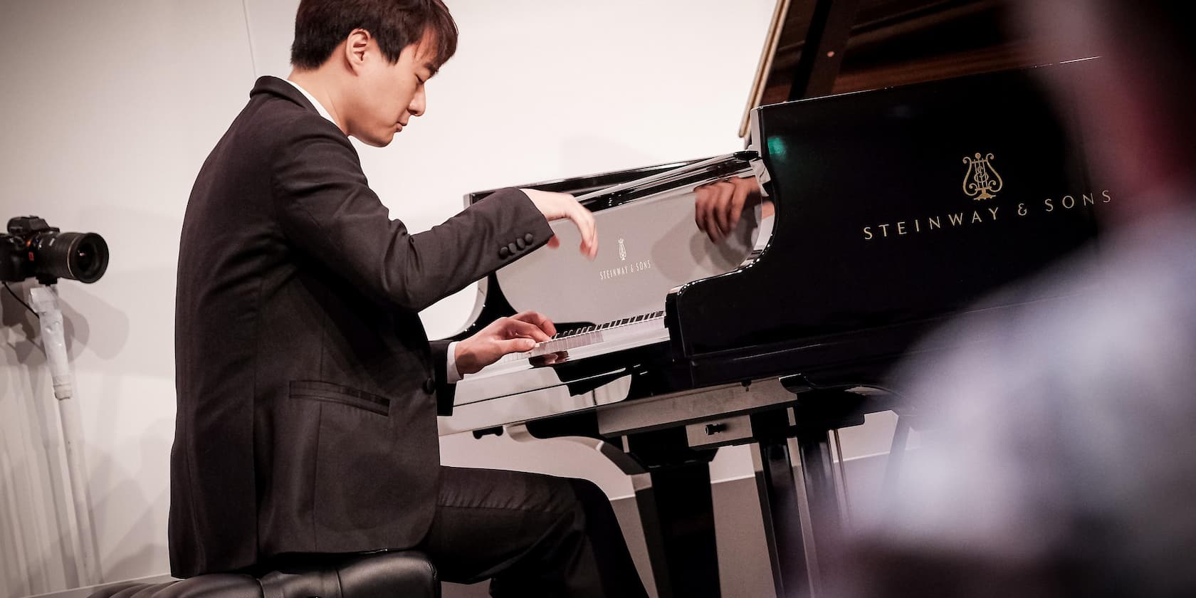 Man playing a Steinway & Sons grand piano