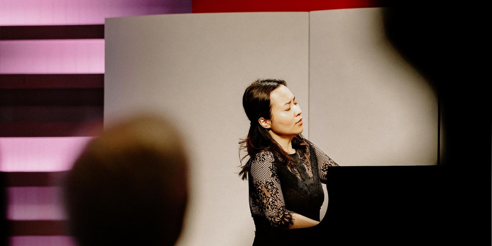 Woman playing piano in a concert hall