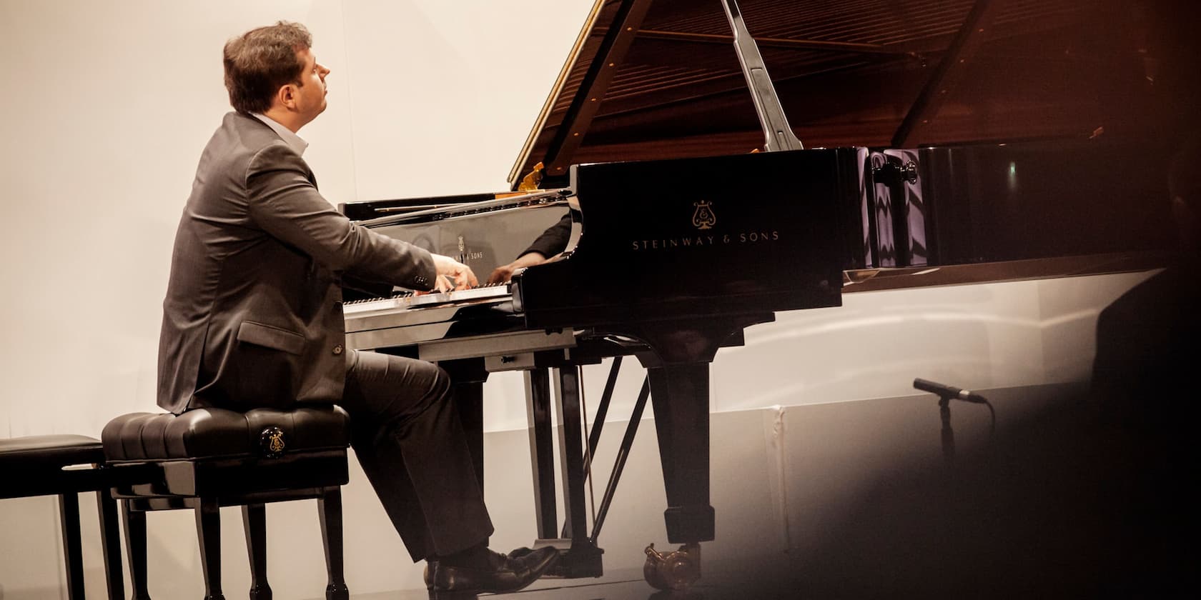 Man in a suit playing the piano