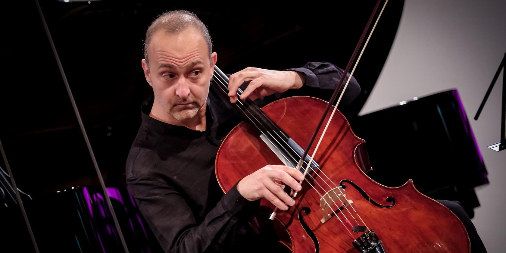 Musician playing cello during a performance