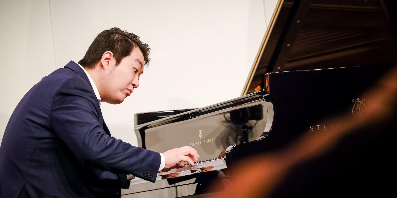 A pianist playing the piano during a concert.