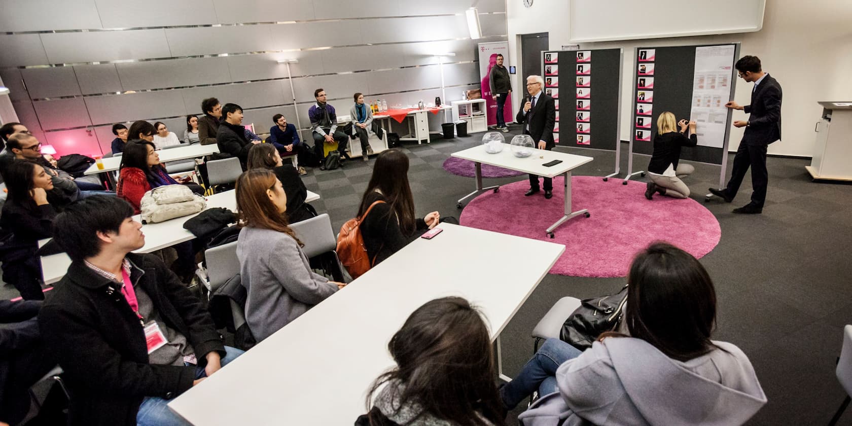 People sitting in a conference room attending a presentation.