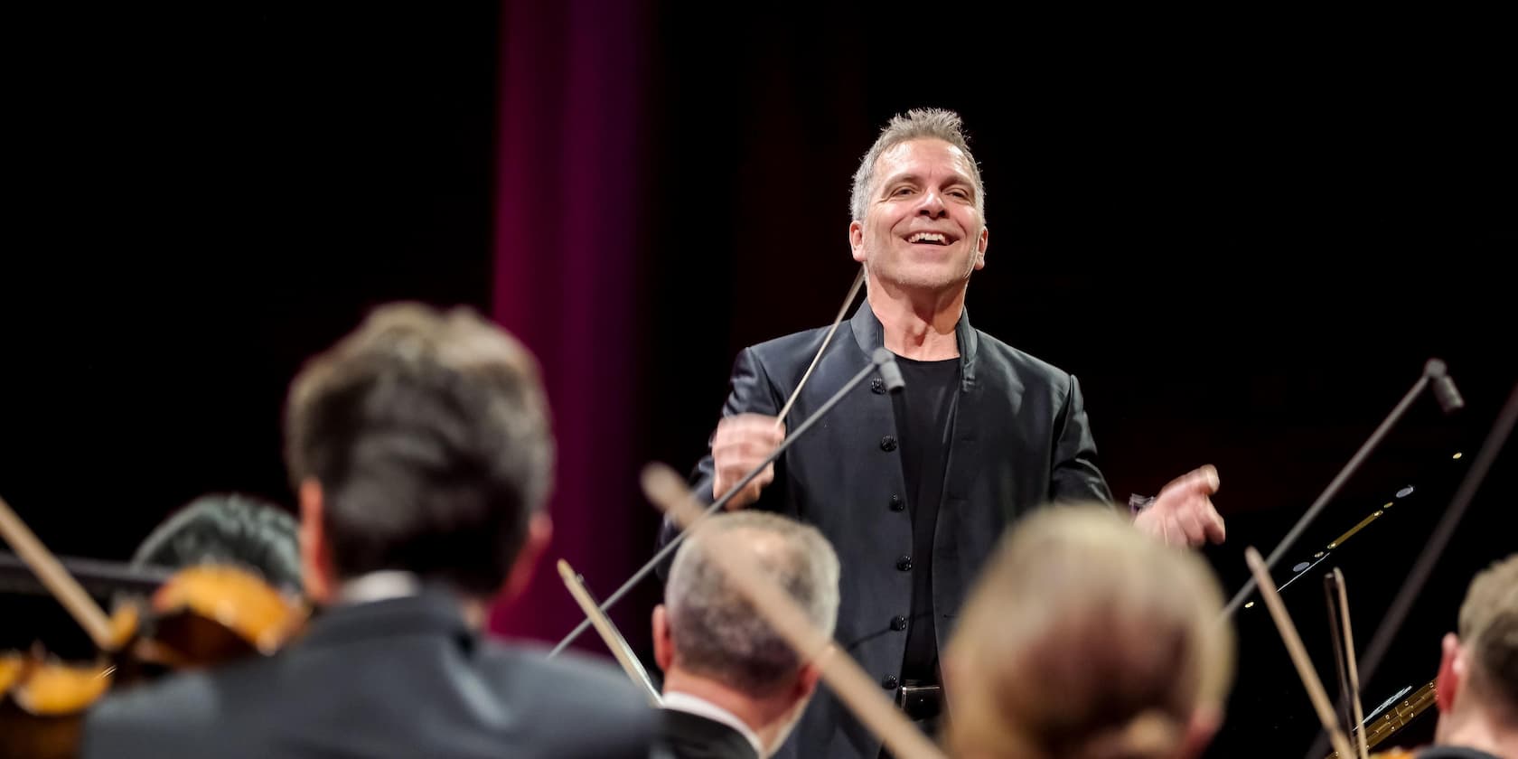 A conductor leading an orchestra during a concert.