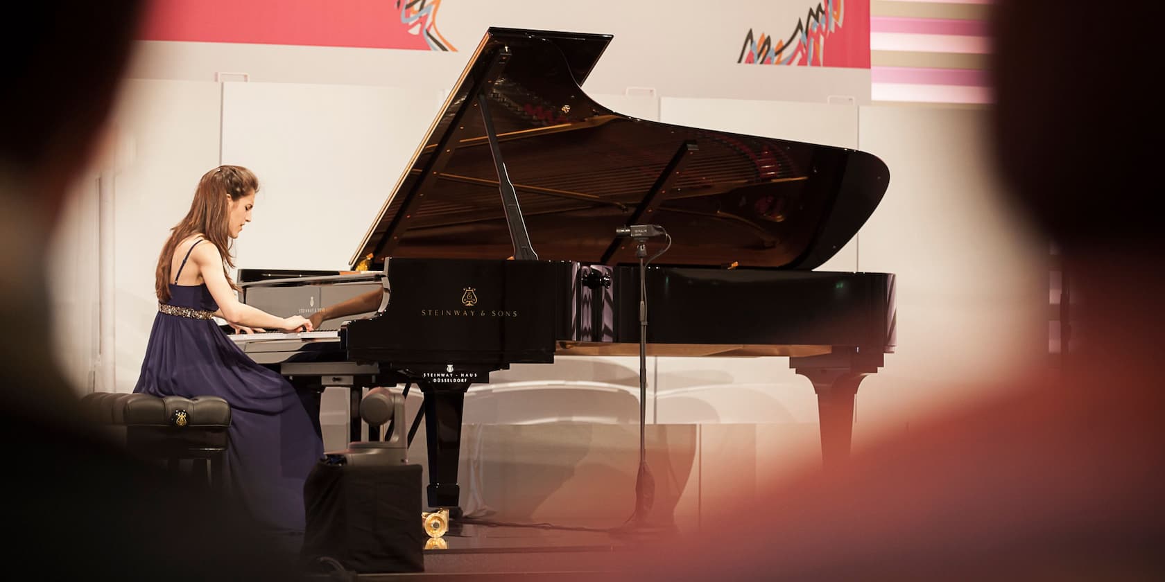 A woman playing piano on stage