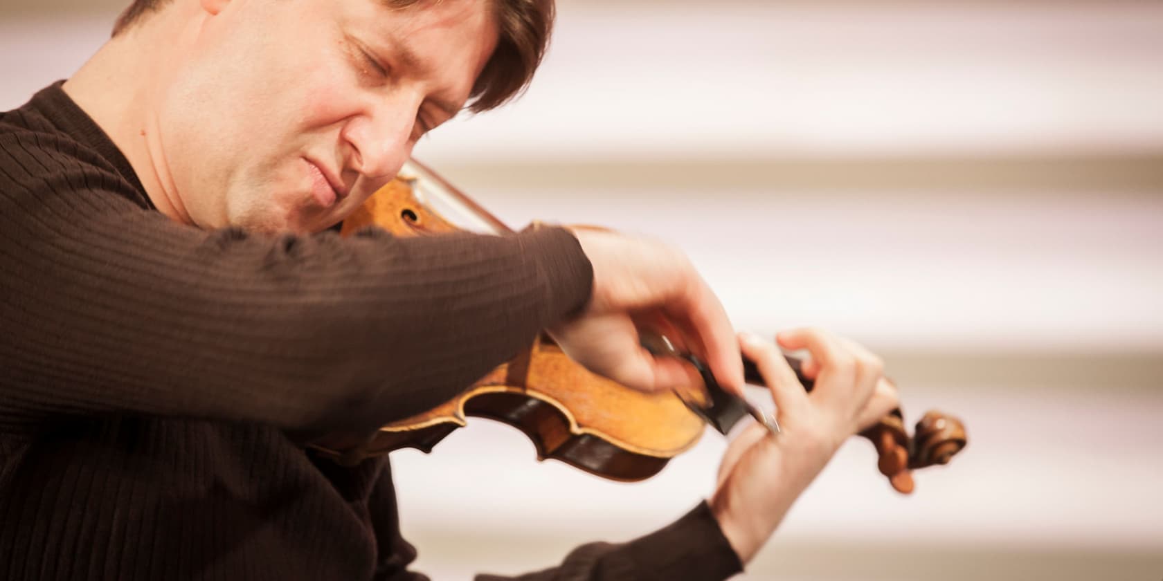 Man passionately playing the violin