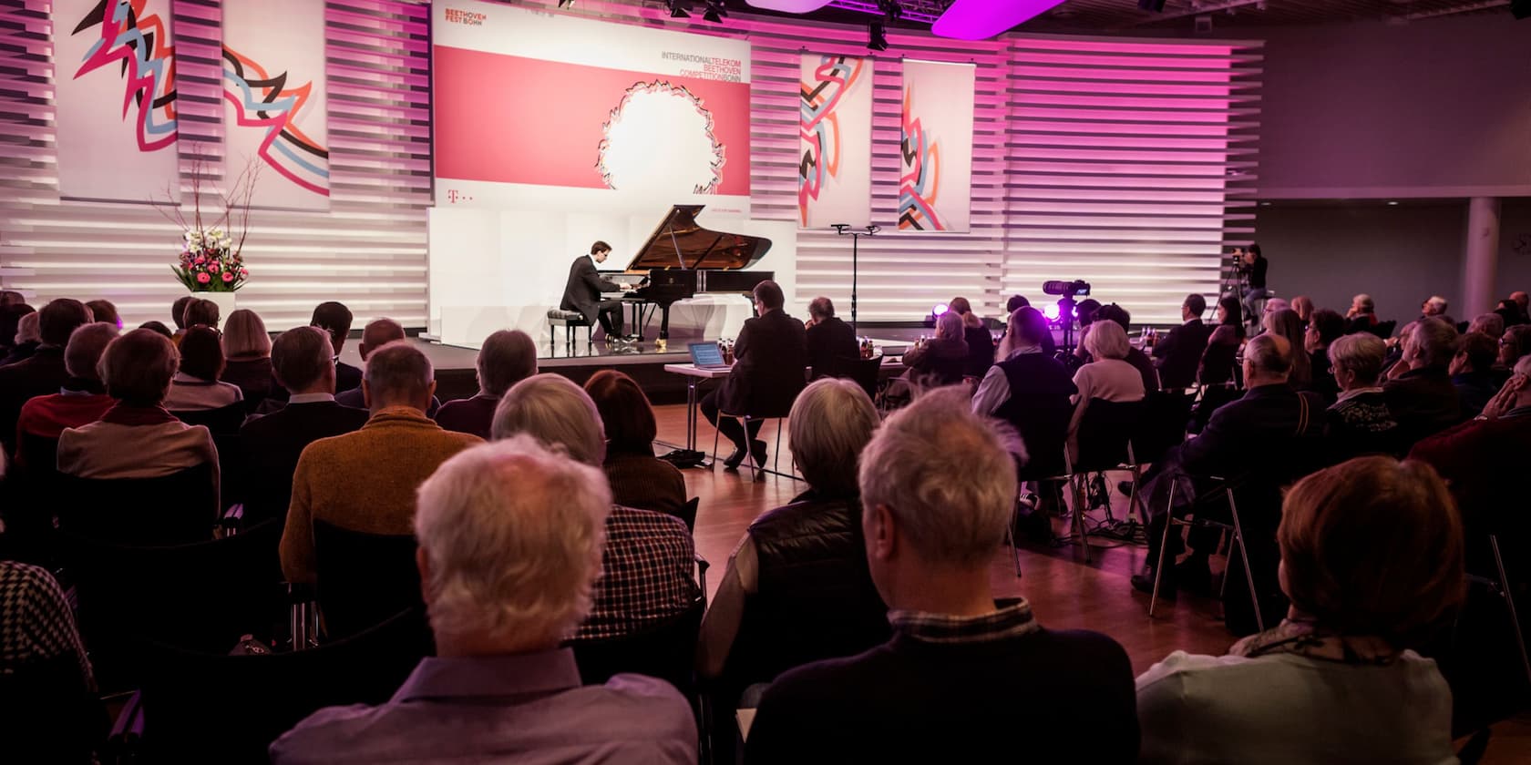 A concert during the Beethoven Festival in Bonn, with a pianist performing in front of an audience.