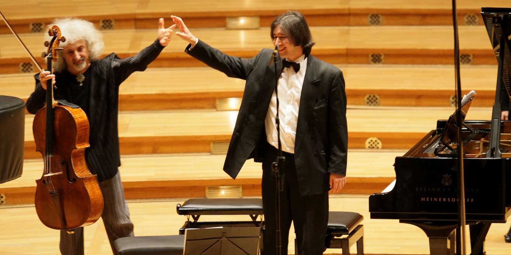 Cellist and pianist bowing after a performance.