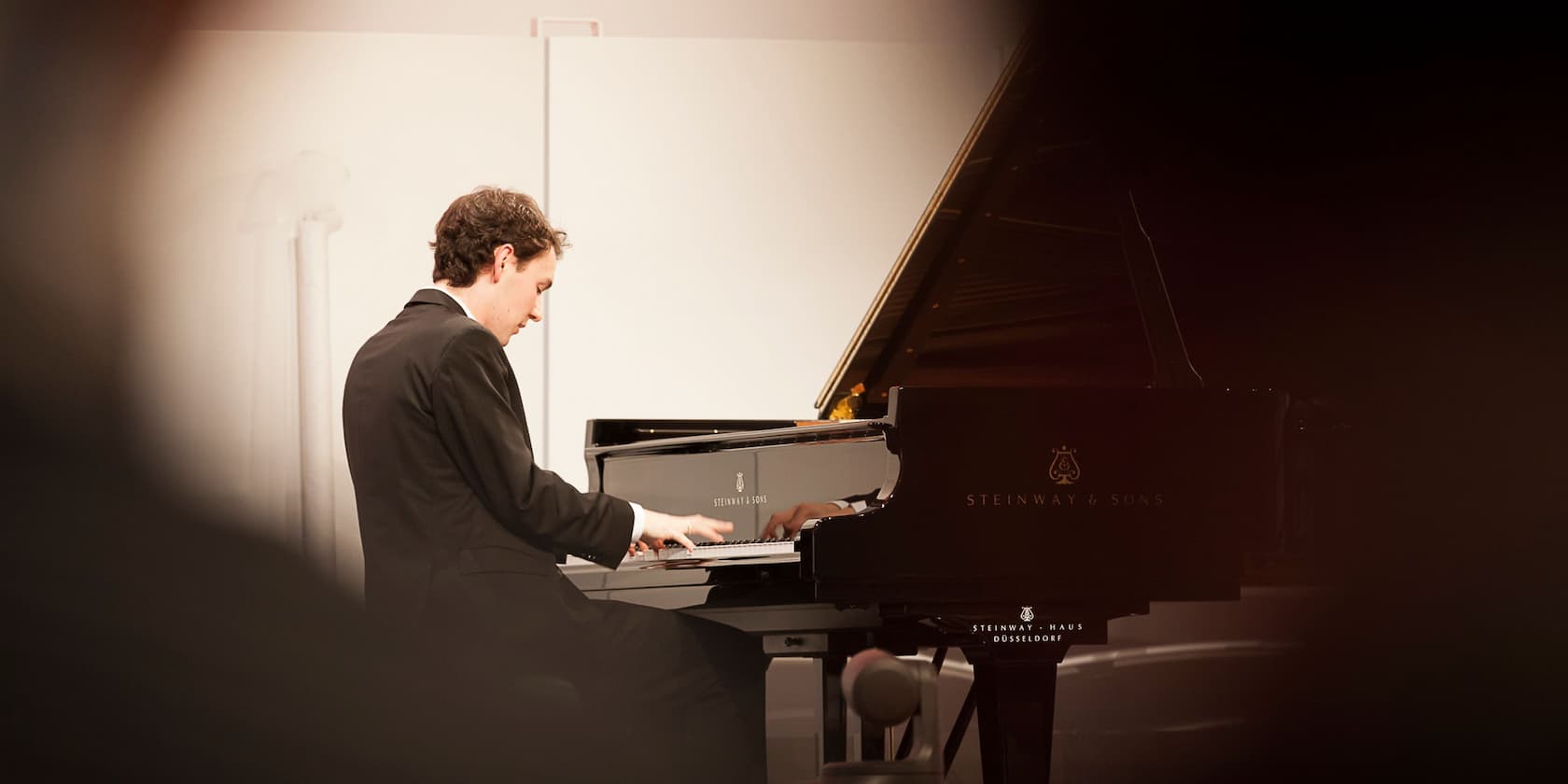 A man playing the piano at a concert.