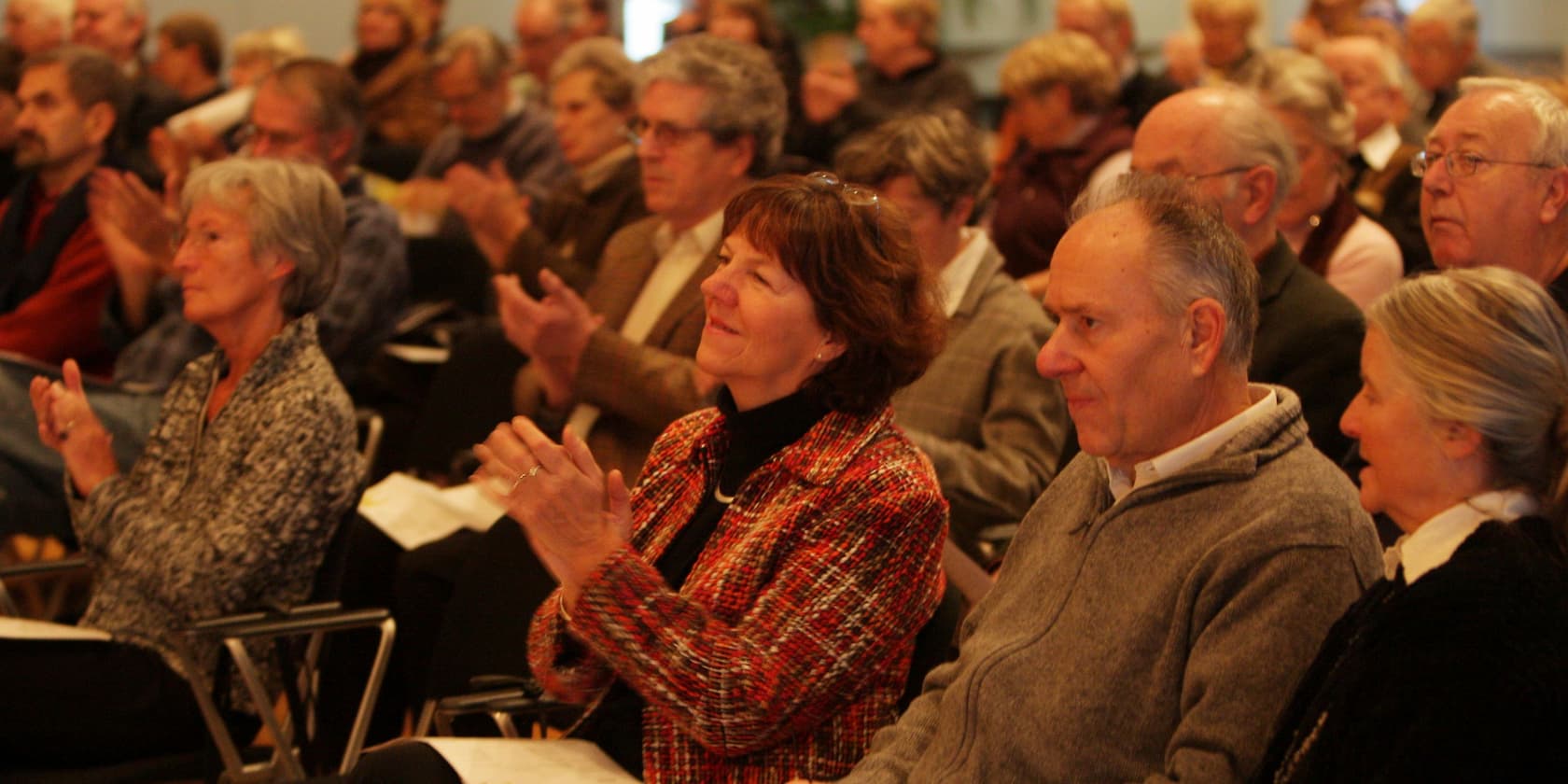 People applauding at a gathering.