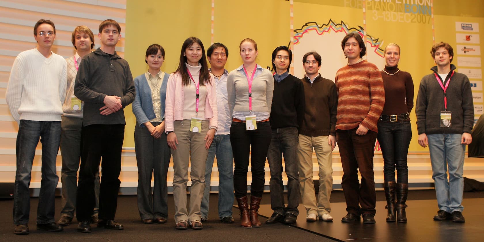 A group of eleven people standing together on a stage during a piano competition in Bonn, December 2007.