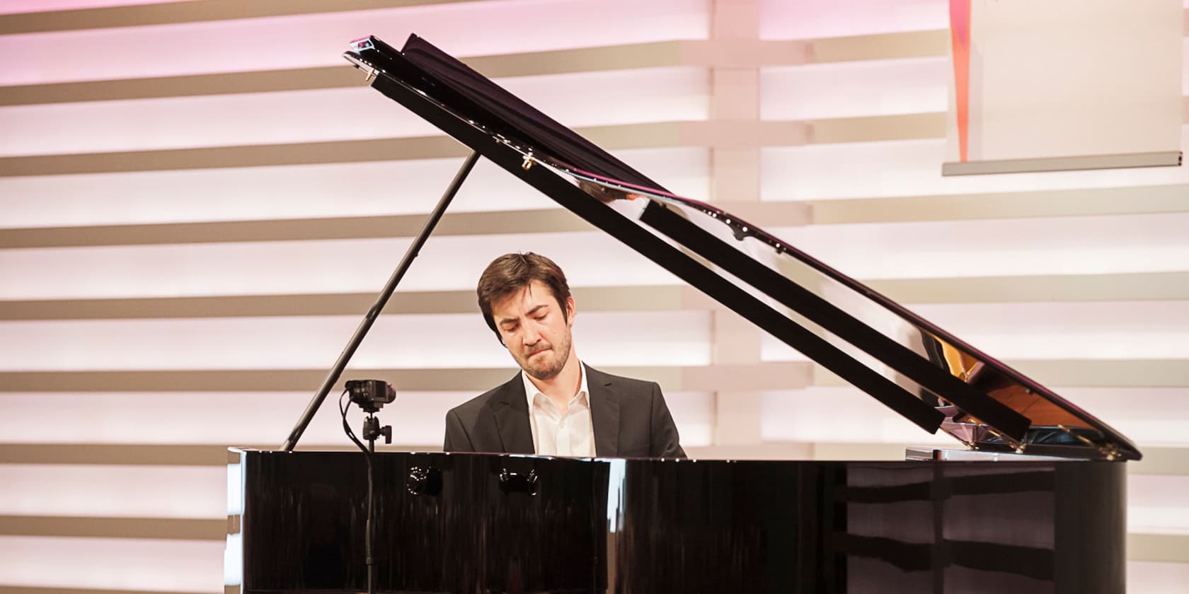 Man playing piano on a stage