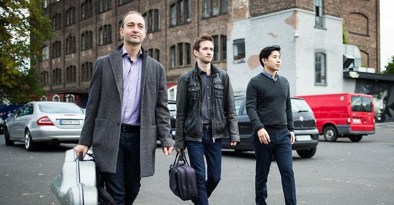 Beethoven Trio walking along a street